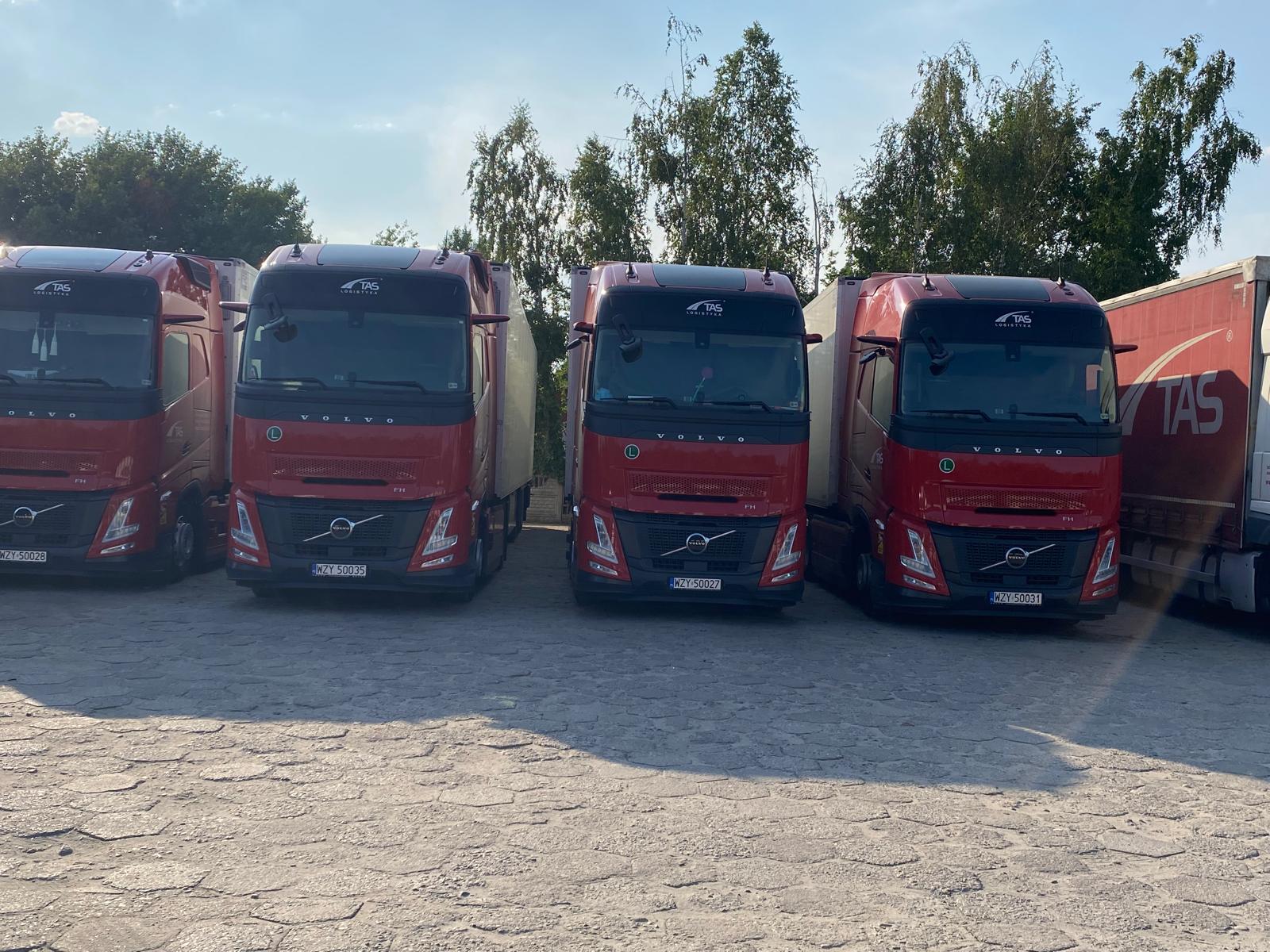 White and red logistics trucks