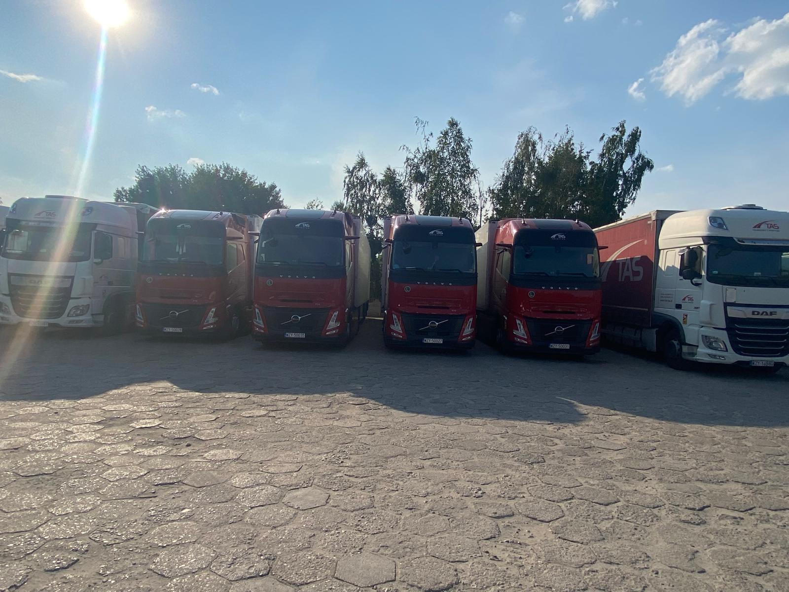 Line of red and white transport trucks
