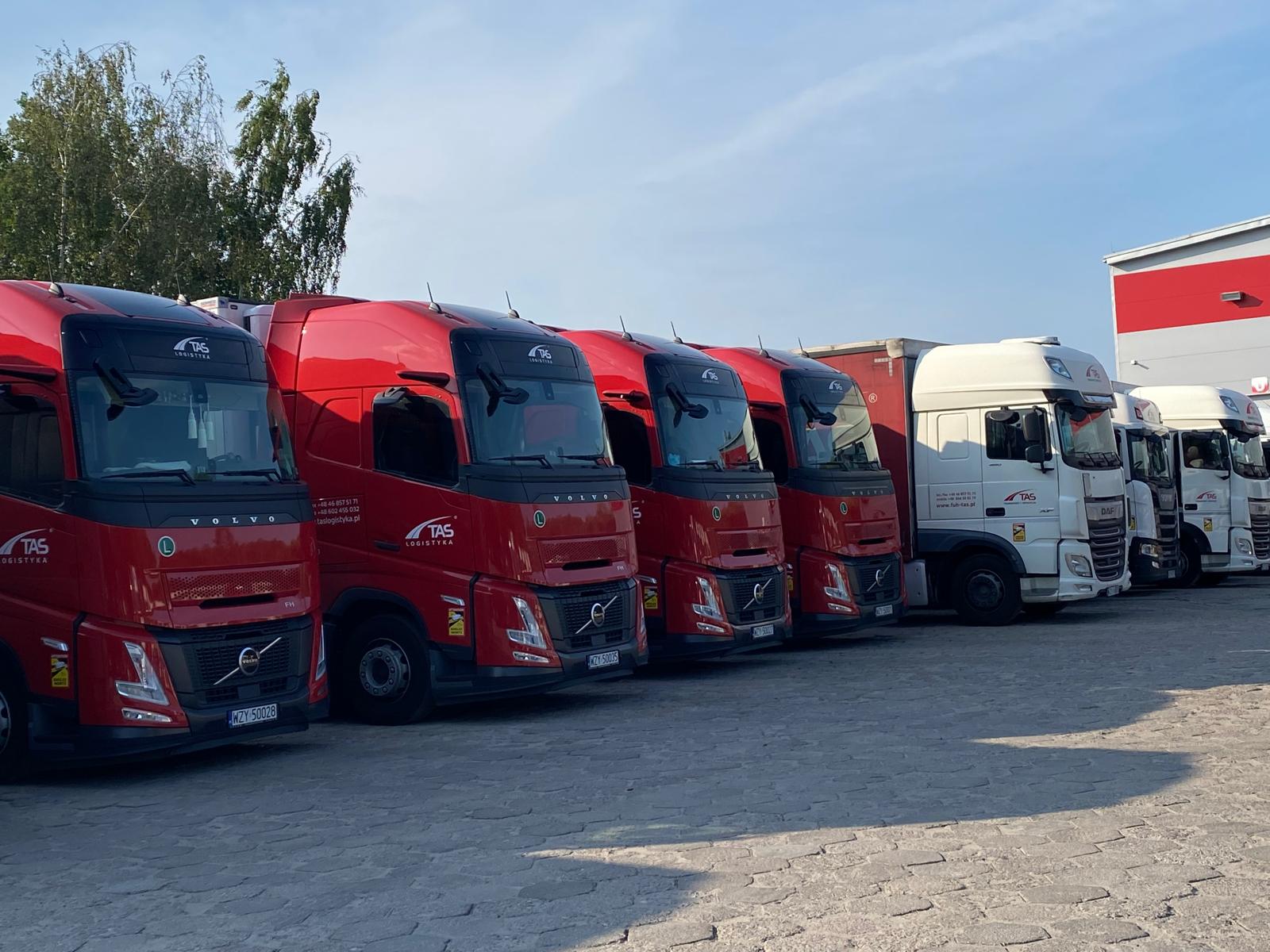 Red logistics trucks and trailers